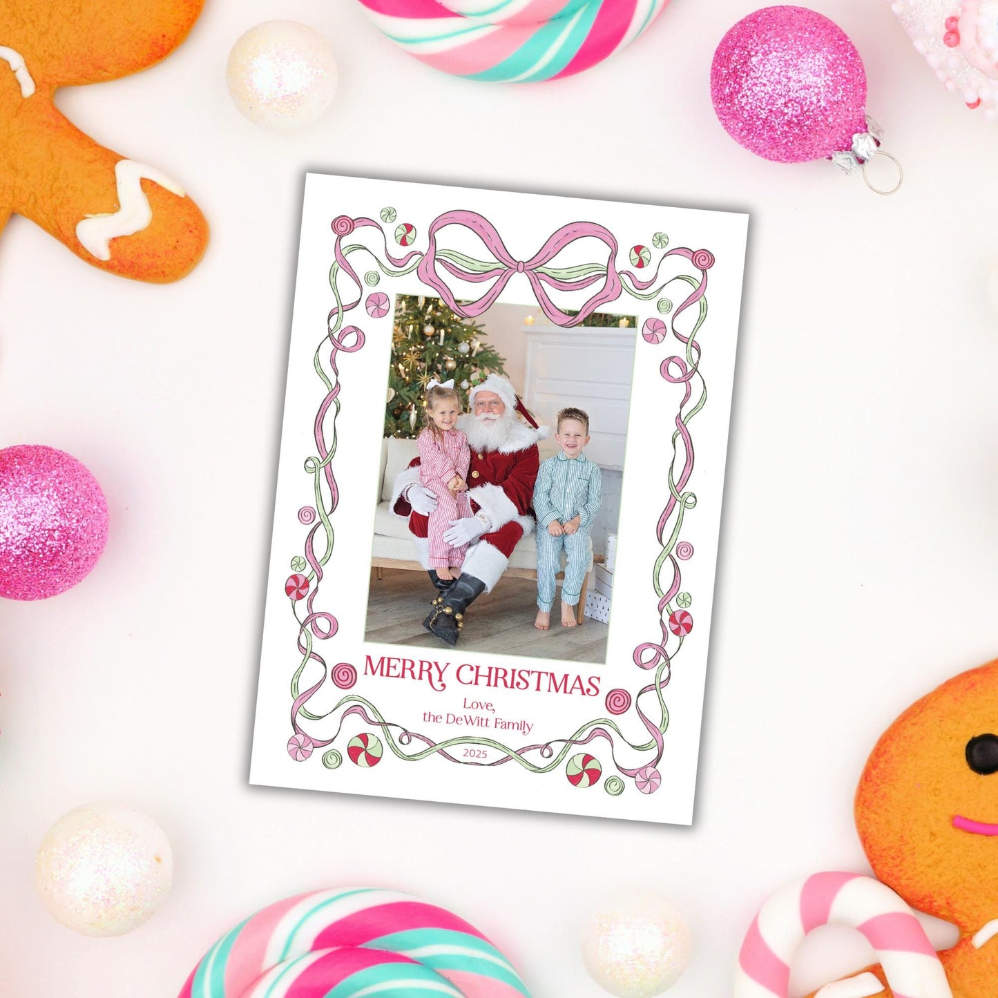 A Christmas-themed photo frame with a Santa Claus photo inside, surrounded by various holiday decorations such as gingerbread cookies, candy canes, and ornaments.