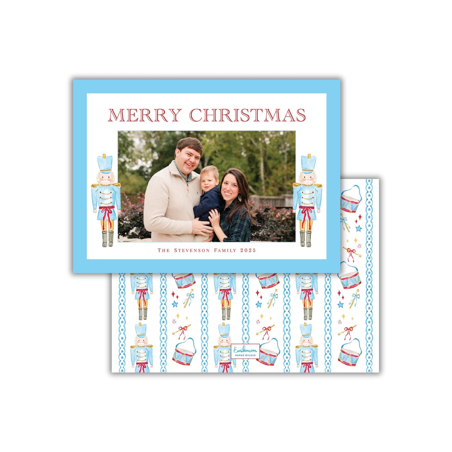 A family photo is displayed in a blue frame, with the text "MERRY CHRISTMAS" written above it. The frame also features nutcracker characters and a pattern of nutcrackers and other Christmas-themed elements.
