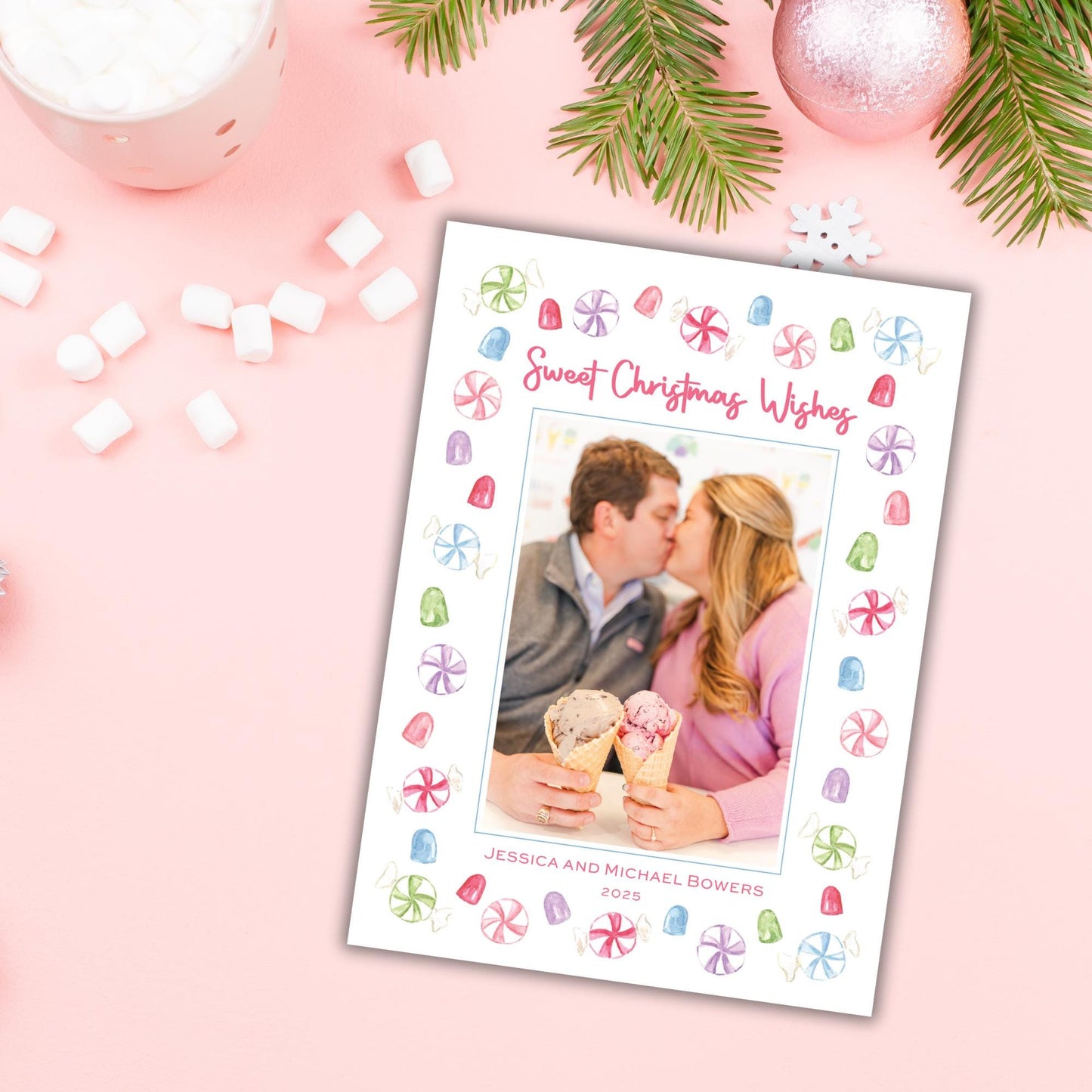 A white card with a photo of a couple kissing and holding ice cream cones, surrounded by colorful candy and a snowflake ornament.