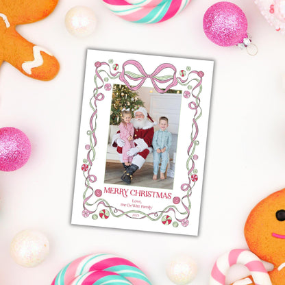 A Christmas-themed photo frame with a Santa Claus photo inside, surrounded by various holiday decorations such as gingerbread cookies, candy canes, and ornaments.