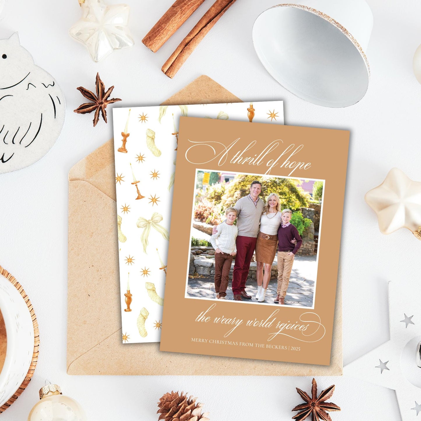 A holiday-themed card with a family photo, surrounded by various holiday decorations such as star anise, cinnamon sticks, and ornaments.