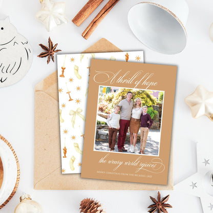 A holiday-themed card with a family photo, surrounded by various holiday decorations such as star anise, cinnamon sticks, and ornaments.