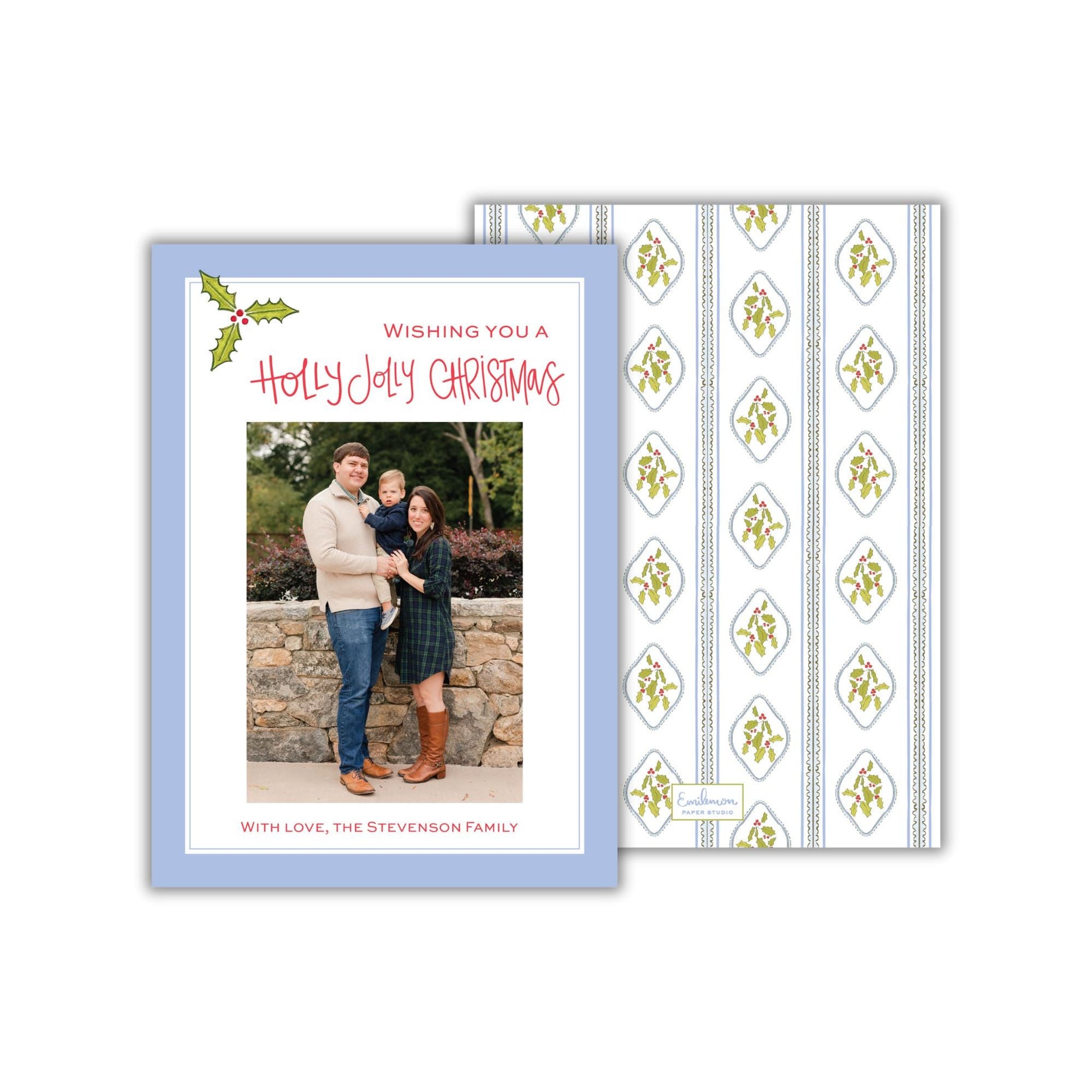 A holiday greeting card featuring a family photo of a man, woman, and child. The card has a blue background with a patterned design and a message wishing the recipient a Merry Christmas.