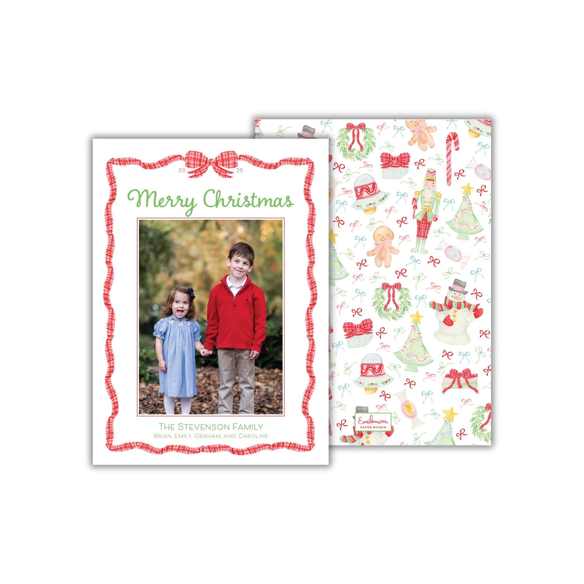 A Christmas-themed card featuring a photo of two children, a boy and a girl, standing together in a forest setting. The card has a red and white border and a festive design with Christmas-related elements such as trees, snowmen, and candy canes.