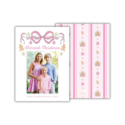 The image is a Christmas card featuring a family portrait of a young girl, a young boy, and a young boy. The card has a pink and white striped background with a bow and stars, and the text "Merry Christmas" is displayed above the family portrait.