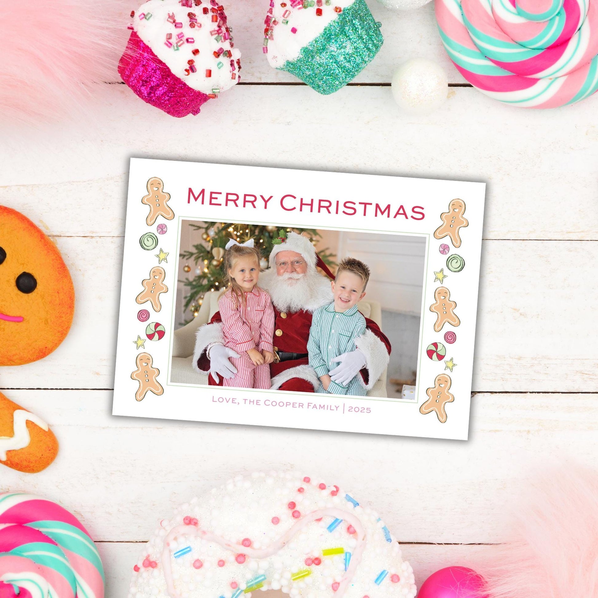 A Christmas-themed photo frame with a photo of Santa Claus and two children, surrounded by various festive decorations such as gingerbread cookies, lollipops, and other holiday items.