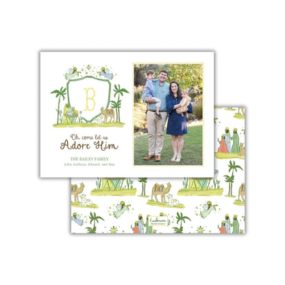 A family portrait of a man, woman, and child, along with a decorative border featuring a letter 'B' and a nativity scene.