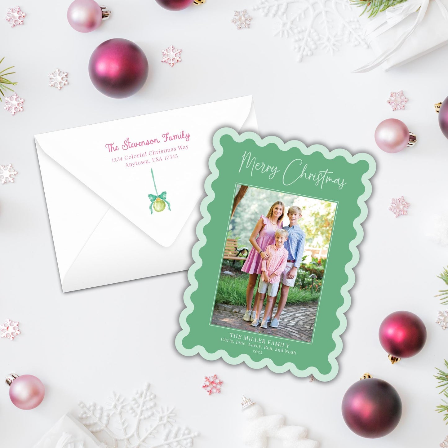 a Christmas card and an envelope on a white background, surrounded by Christmas ornaments and snowflakes.