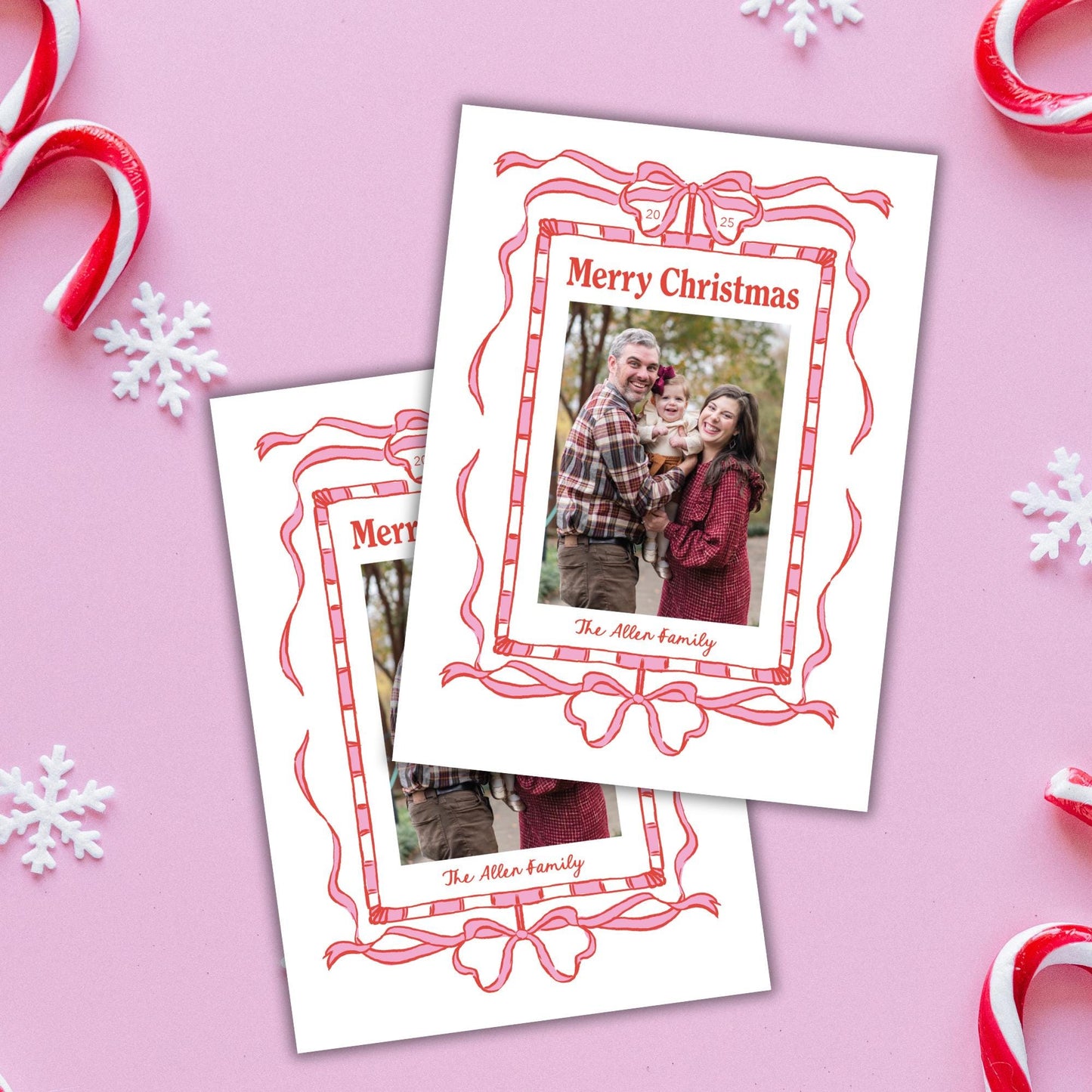 a pair of Christmas cards with a festive design, including red and white ribbons, snowflakes, and candy canes.