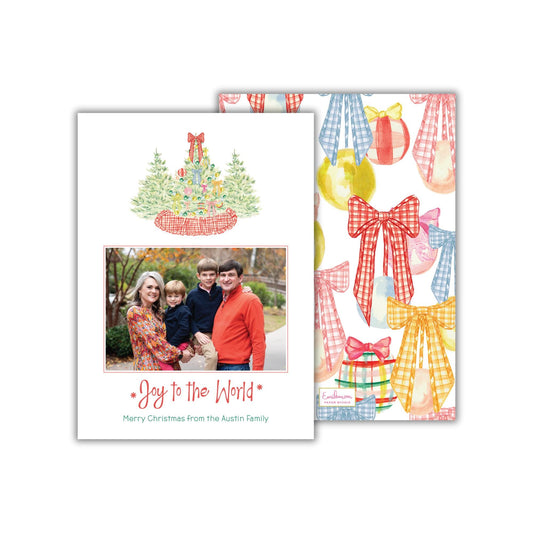 A Christmas card featuring a family photo and a pattern of colorful bows and presents.