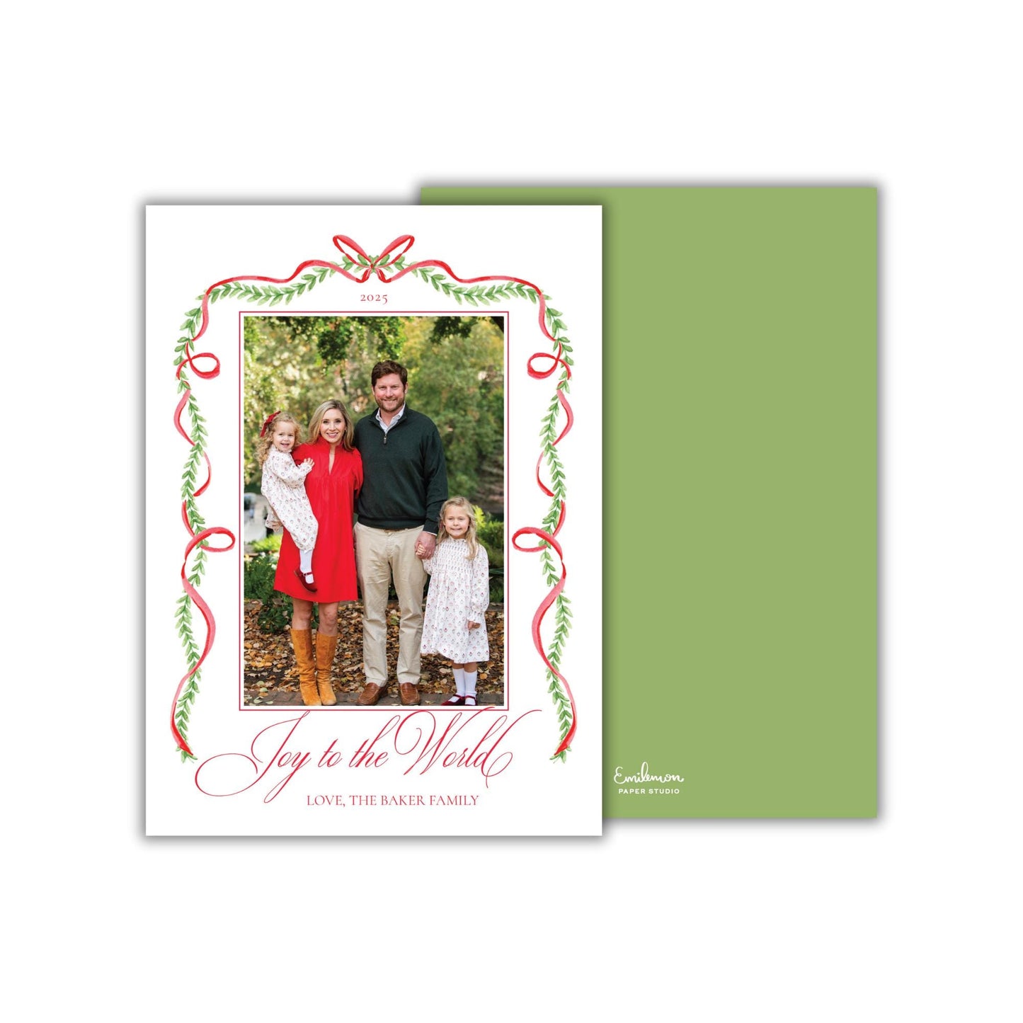 A family portrait of a man, woman, and two young girls, surrounded by a decorative border with red and green ribbons. The text on the card reads &quot;Joy to the World, Love, the Baker Family&quot;.