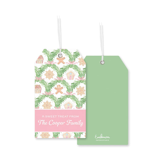 two tags, one with a pink background and the other with a green background, both displaying a pattern of Christmas ornaments and greenery.