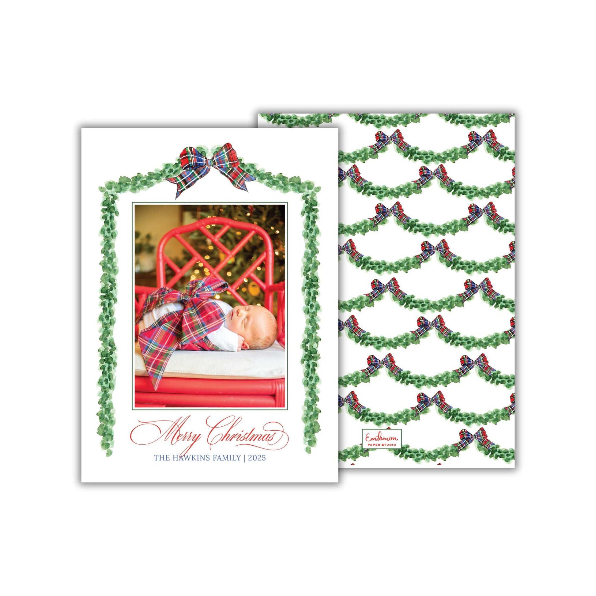 A Christmas card featuring a baby swaddled in a plaid blanket, with a red chair and a Christmas tree in the background. The card has a festive design with green and red bows, and the text &quot;Merry Christmas&quot; and &quot;The Hawkins Family (2023)&quot; is displayed.
