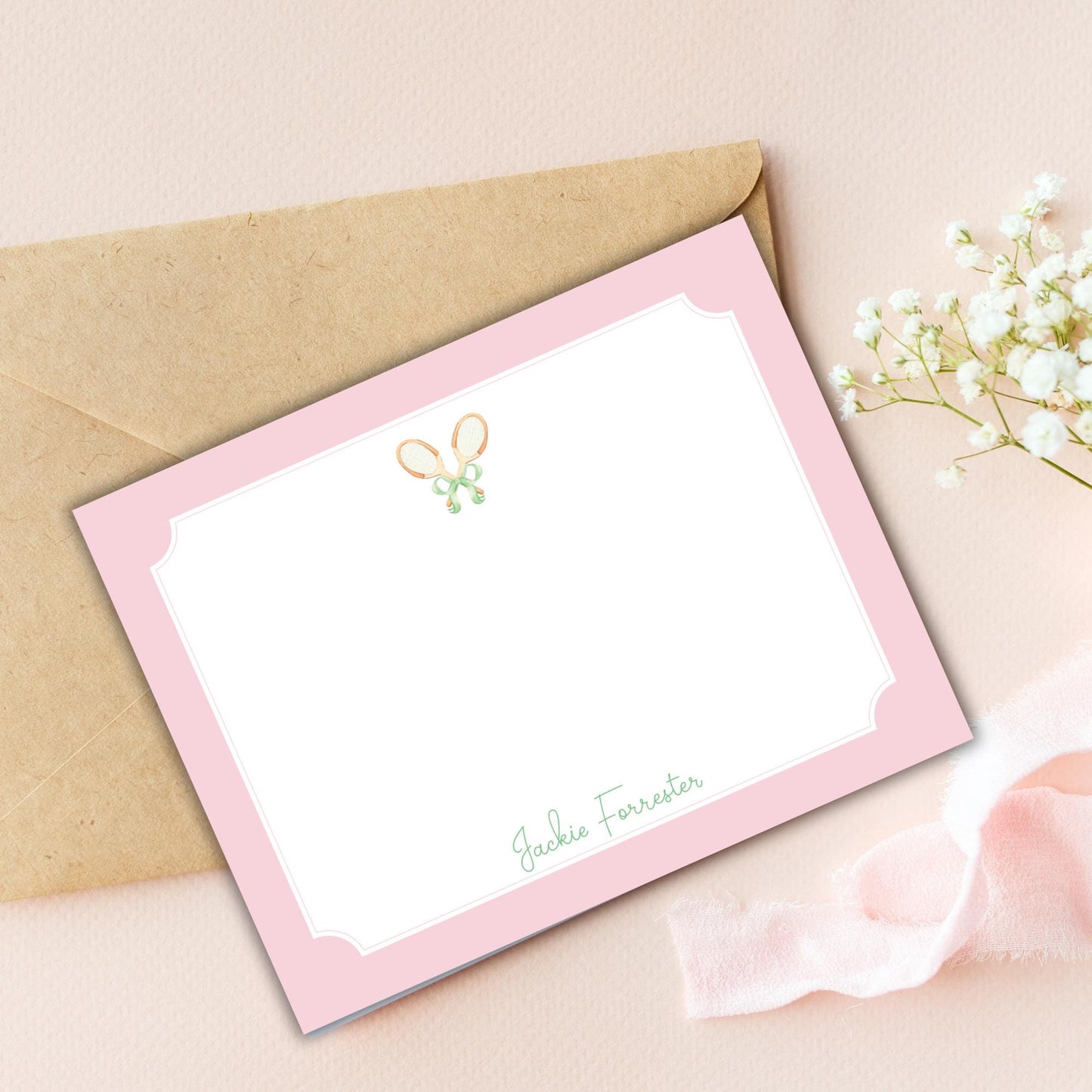 a card with a bow on it next to a flower
