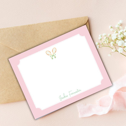 a card with a bow on it next to a flower