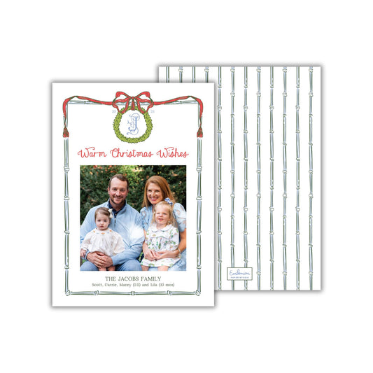 A family portrait of a man, woman, and two children, with the text &quot;Warm Christmas Wishes&quot; and &quot;THE JACOBS FAMILY&quot; displayed on the card.