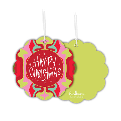 a pair of Christmas-themed ornaments hanging from strings. The ornaments have a vibrant, colorful design with a central red circle surrounded by a pattern of pink, green, and yellow swirls. The text "Happy Christmas" is prominently displayed in the center of the red circle.