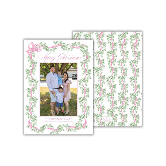 A family portrait of a man, woman, and two children, surrounded by a decorative border of green leaves and pink ribbons. The text &quot;Merry Christmas&quot; is written above the family photo.