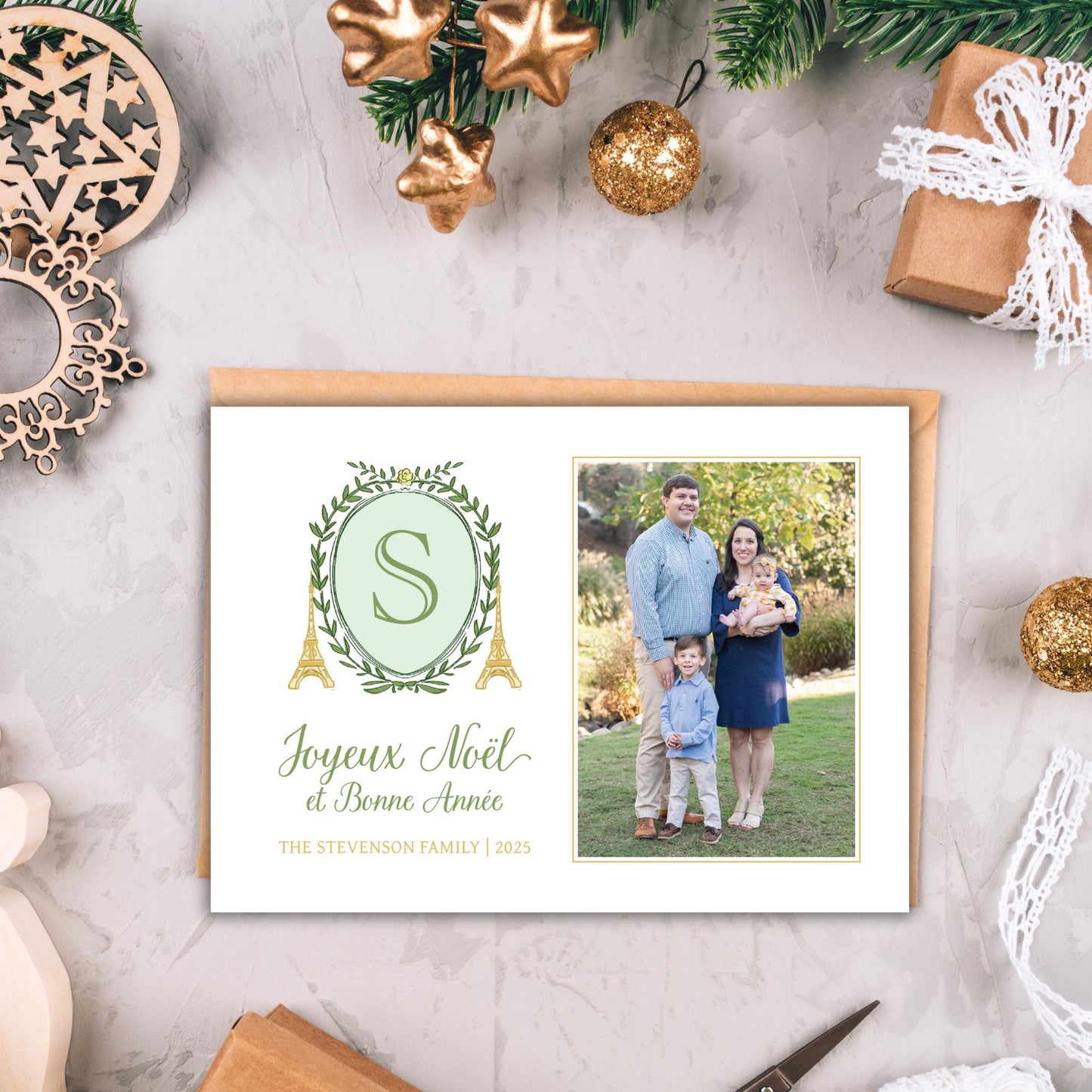 A holiday greeting card featuring a family photo and a decorative element with gold ornaments and a star-shaped ornament.