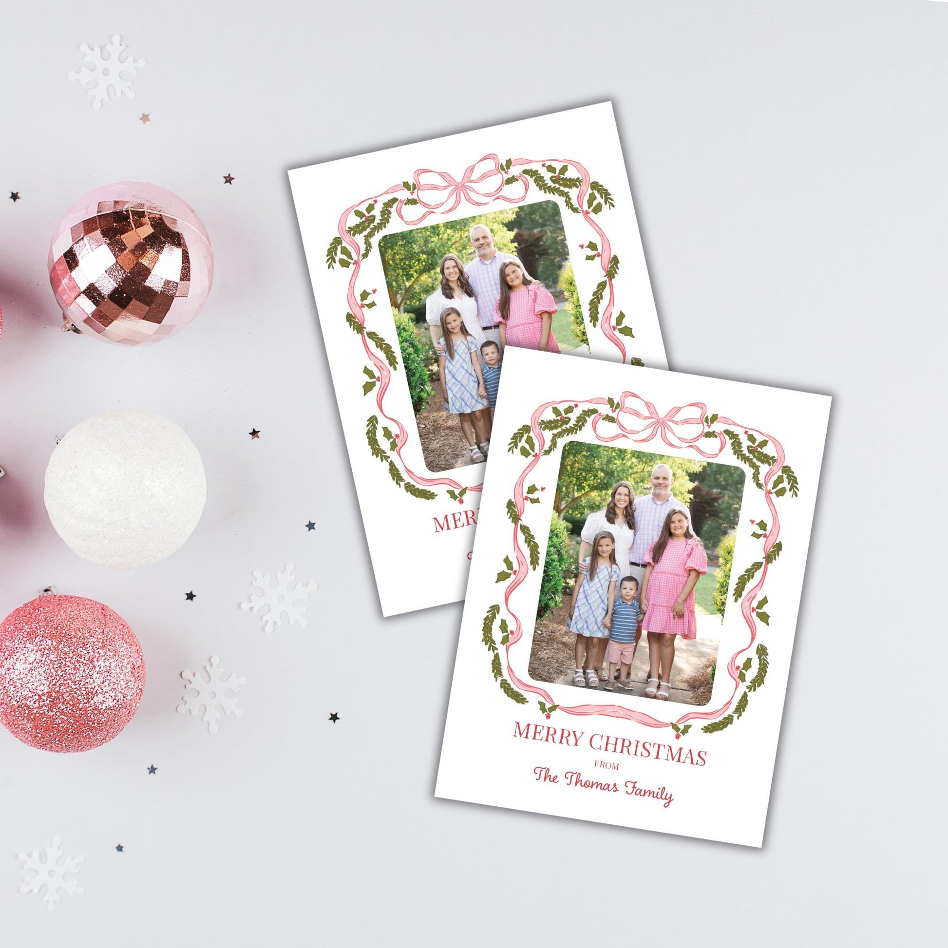 a family portrait of a group of people, likely a family, with a festive holiday theme. The family is surrounded by Christmas ornaments and snowflakes, creating a warm and joyful atmosphere.