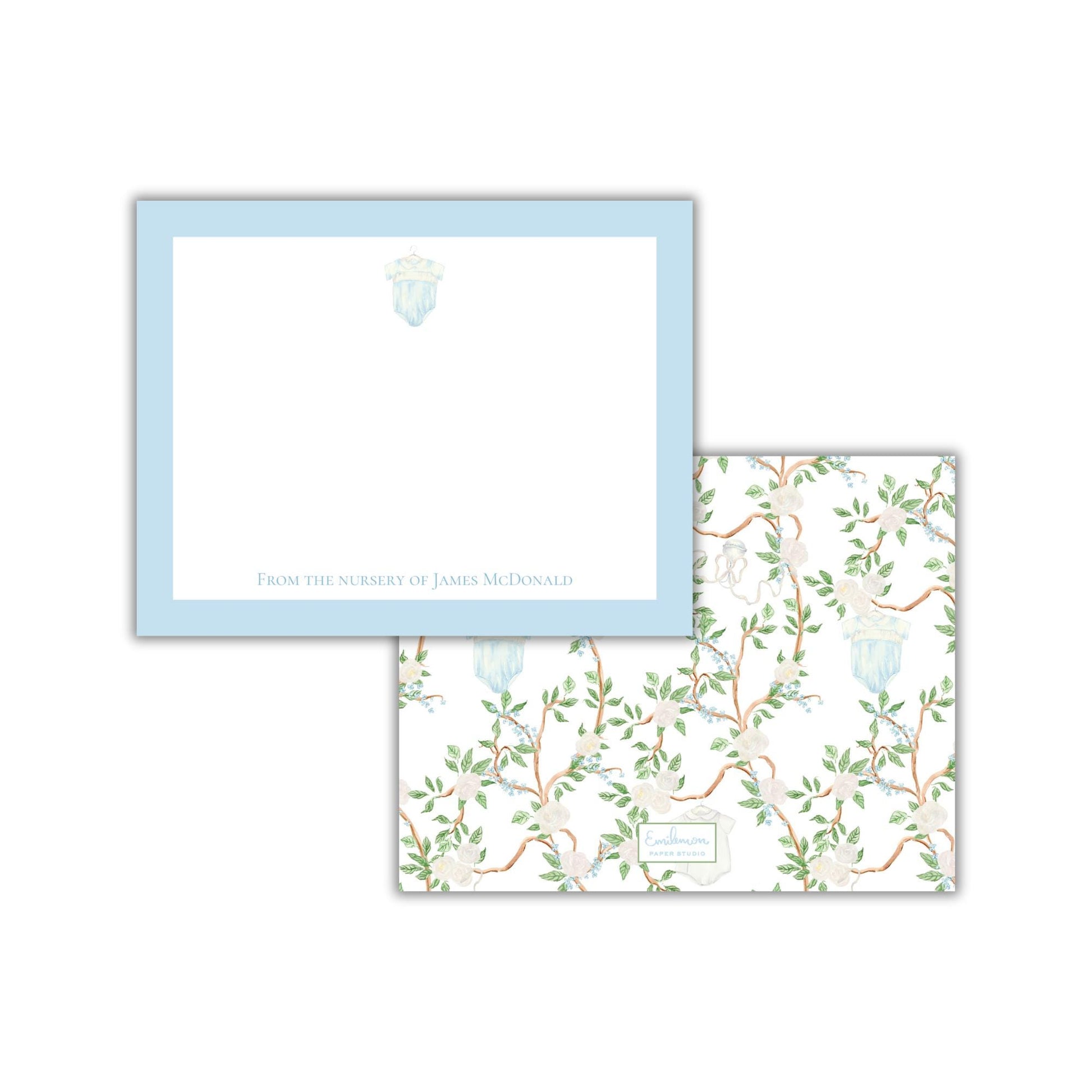 two pieces of paper with different designs. The top paper has a plain white background with a blue border and a small illustration of a flower. The bottom paper has a floral pattern with green leaves and branches.