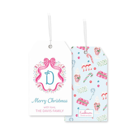 two tags with Christmas-themed designs hanging against a white background.