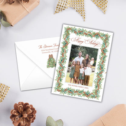 A holiday greeting card with a family photo and a white envelope with a holiday-themed design.