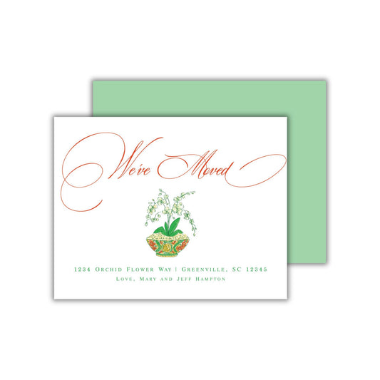The image is a greeting card with a message that reads "We've moved" in a cursive font. The card has a green background and a white border.