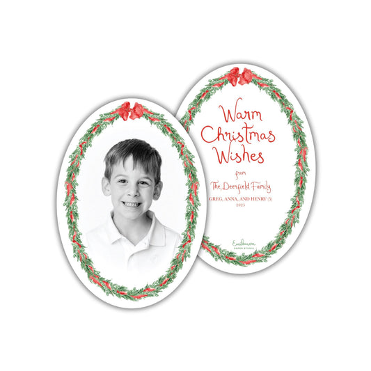 The image is a Christmas card featuring a young boy&#39;s portrait, surrounded by a wreath design. The card has a warm, festive message that reads &quot;Warm Christmas Wishes from The DePelfoot Family, Greg, Anna, and Henry (3/20/2022)&quot;.