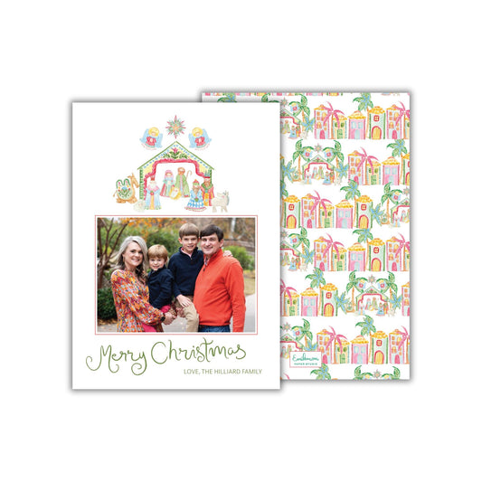 A Christmas card featuring a family photo and a repeating pattern of colorful houses.