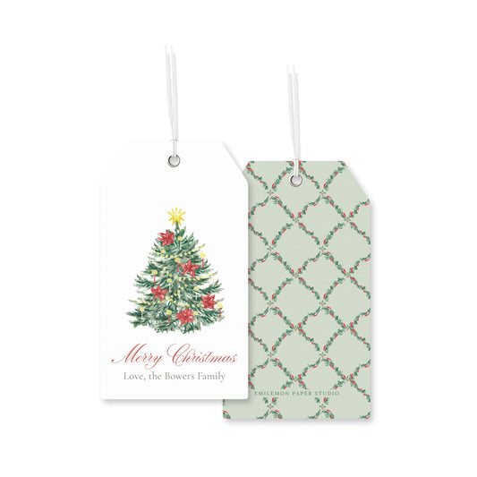 two Christmas-themed gift tags hanging against a white background. The tag on the left displays a Christmas tree with red and green ornaments, and the tag on the right has a repeating pattern of green and red holly leaves.
