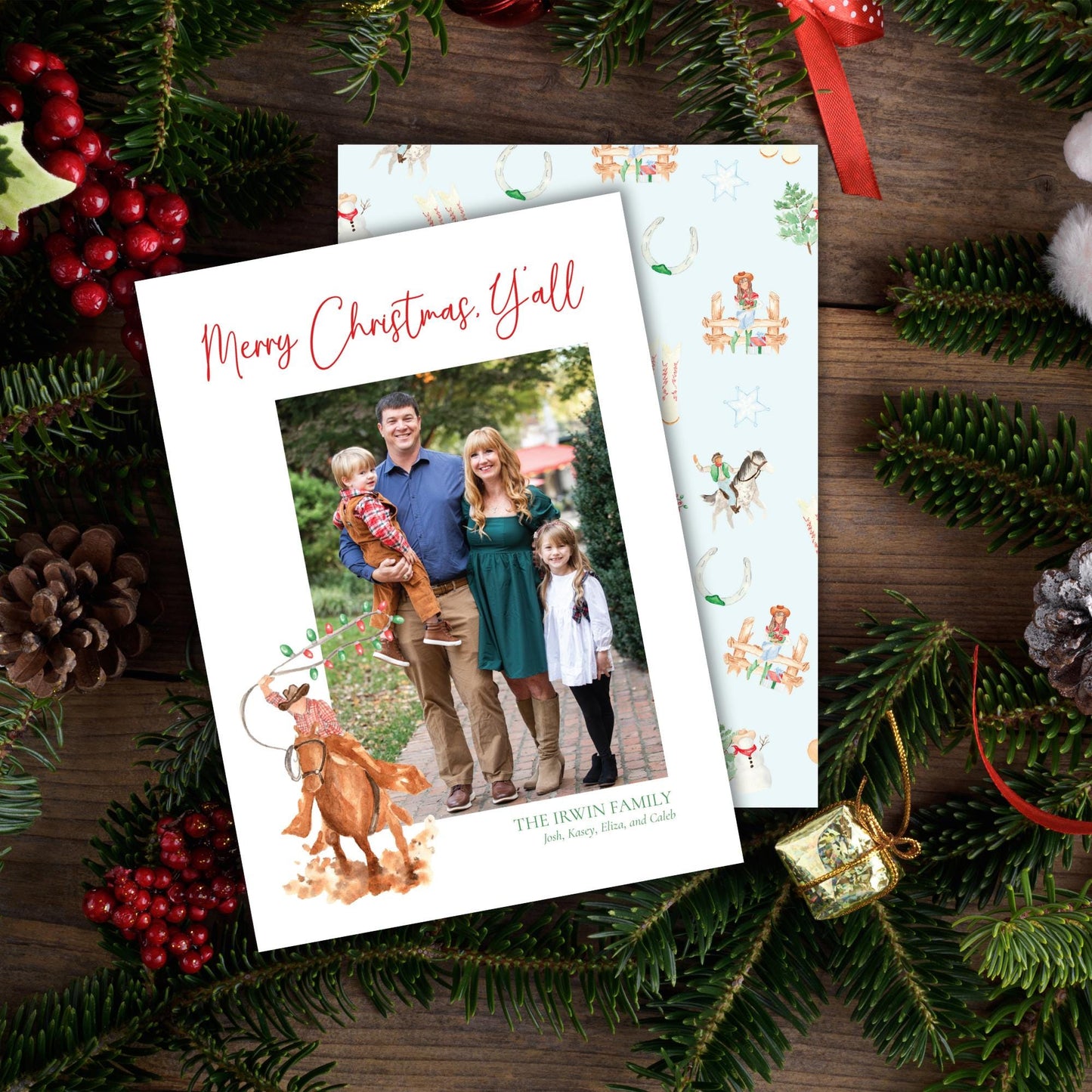 A Christmas card featuring a family photo surrounded by holiday decorations such as pine cones, berries, and ornaments.