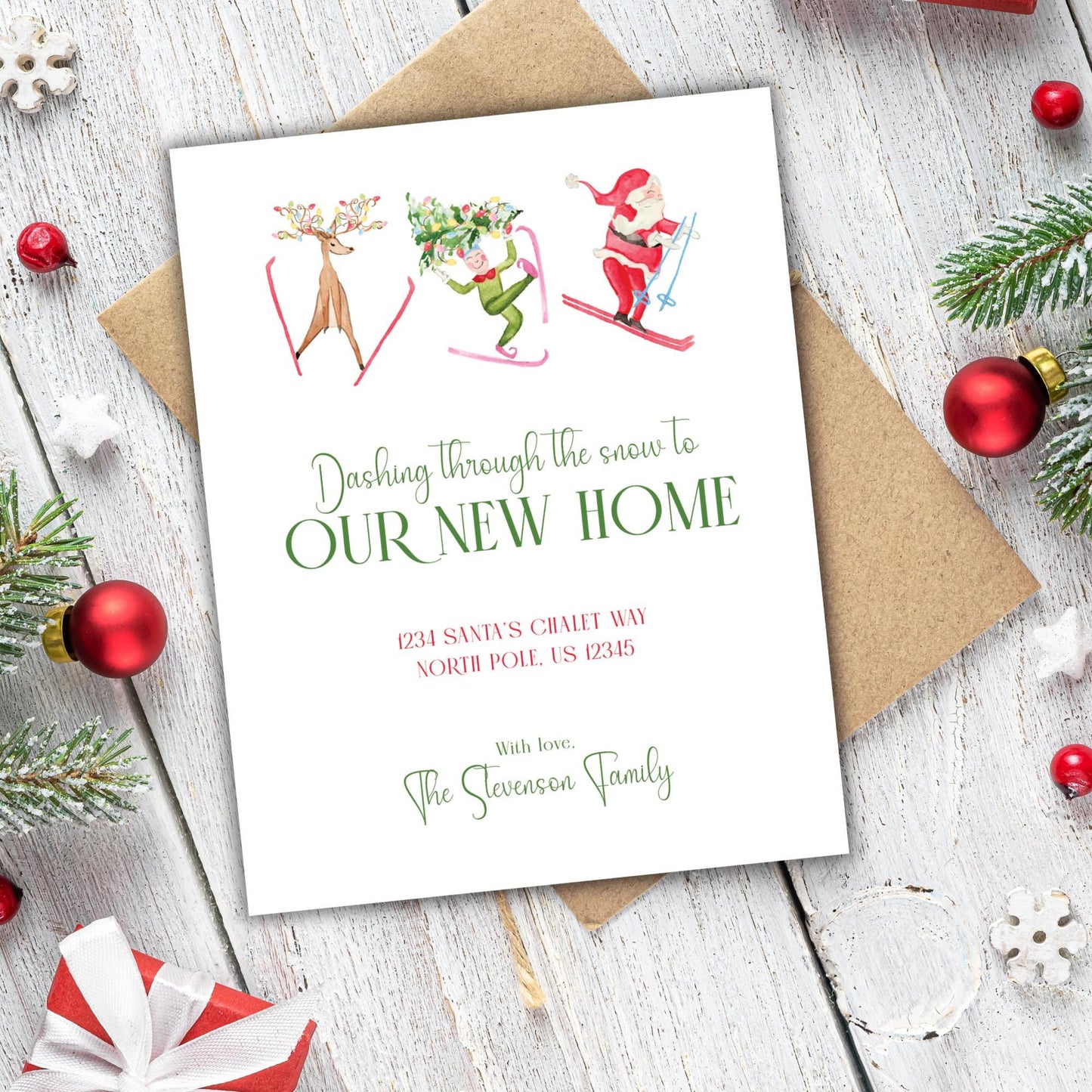 A white card with Christmas decorations and ornaments is placed on a wooden surface.