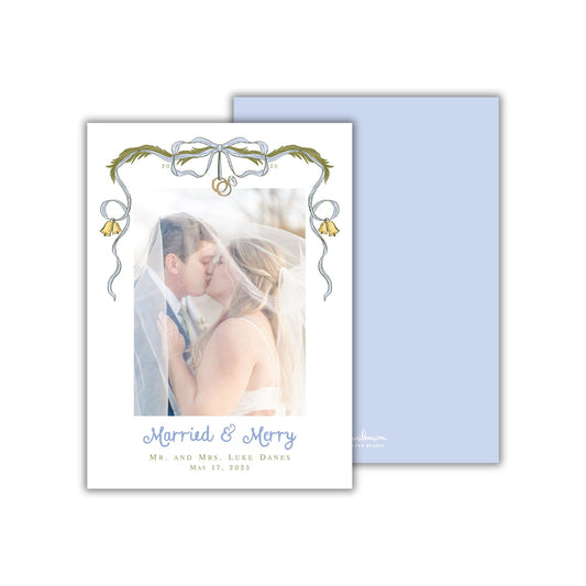 A wedding invitation card featuring a couple embracing and kissing, with the text &quot;Married & Merry&quot; and &quot;Mr. and Mrs. Lyle Danes May 17, 2015&quot; printed on it.