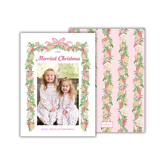 A 2015 holiday card featuring two young girls in a festive floral frame, with a pink and green color scheme.