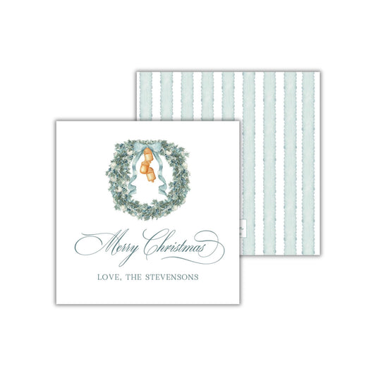 A Christmas card with a wreath design and a personalized message.