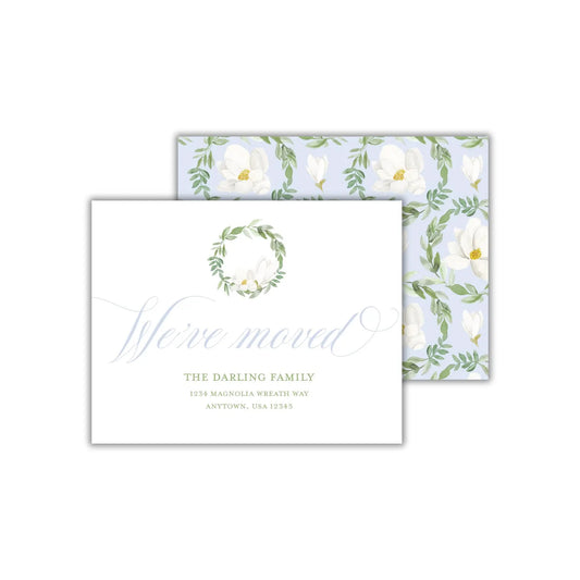 two cards with white flowers and green leaves on them
