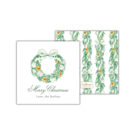 The image is a Christmas card featuring a wreath with orange and white ornaments, along with a personalized message and a repeating pattern of green and white leaves.