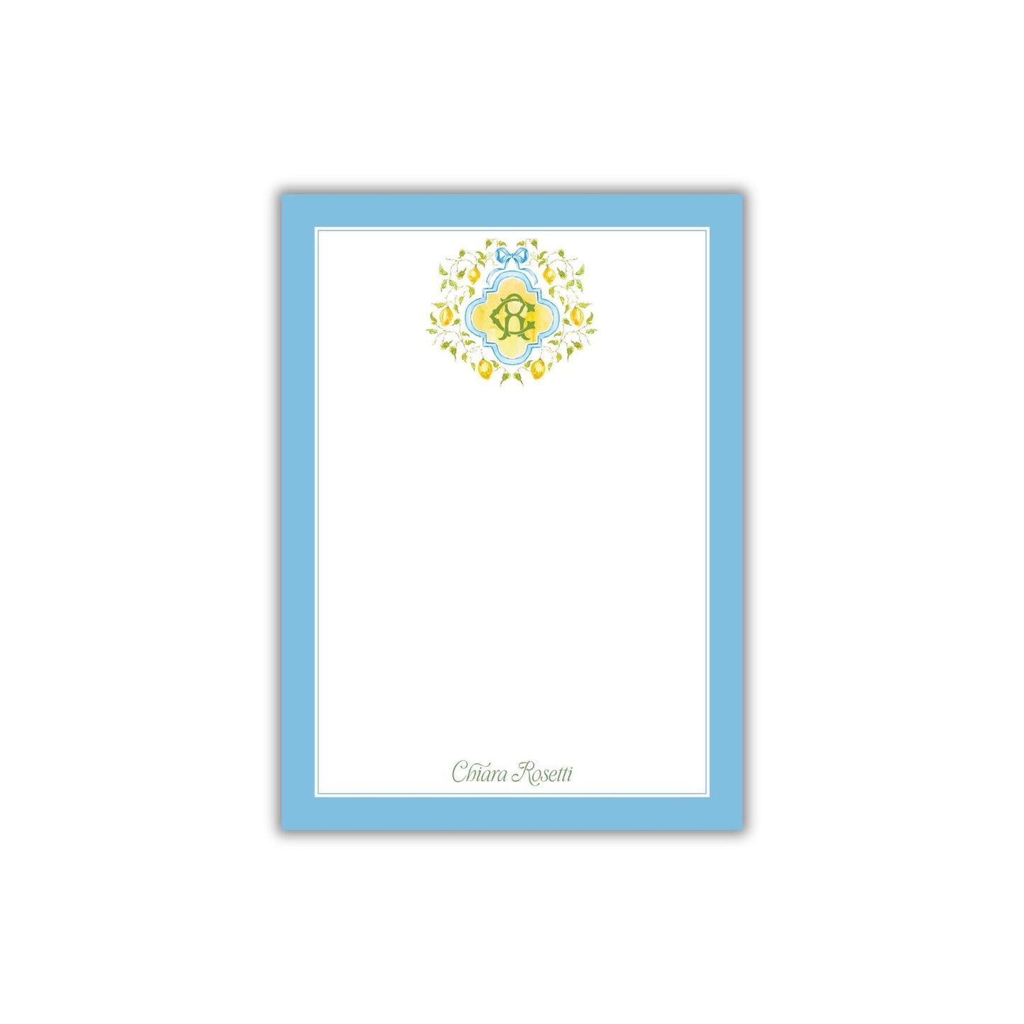 A blue-bordered, white-blank card with a decorative floral design on the top.