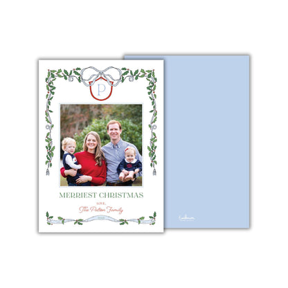 A family portrait of a man, woman, and two children, with the text "MERRIEST CHRISTMAS" and "The Paterson Family" displayed on the card.