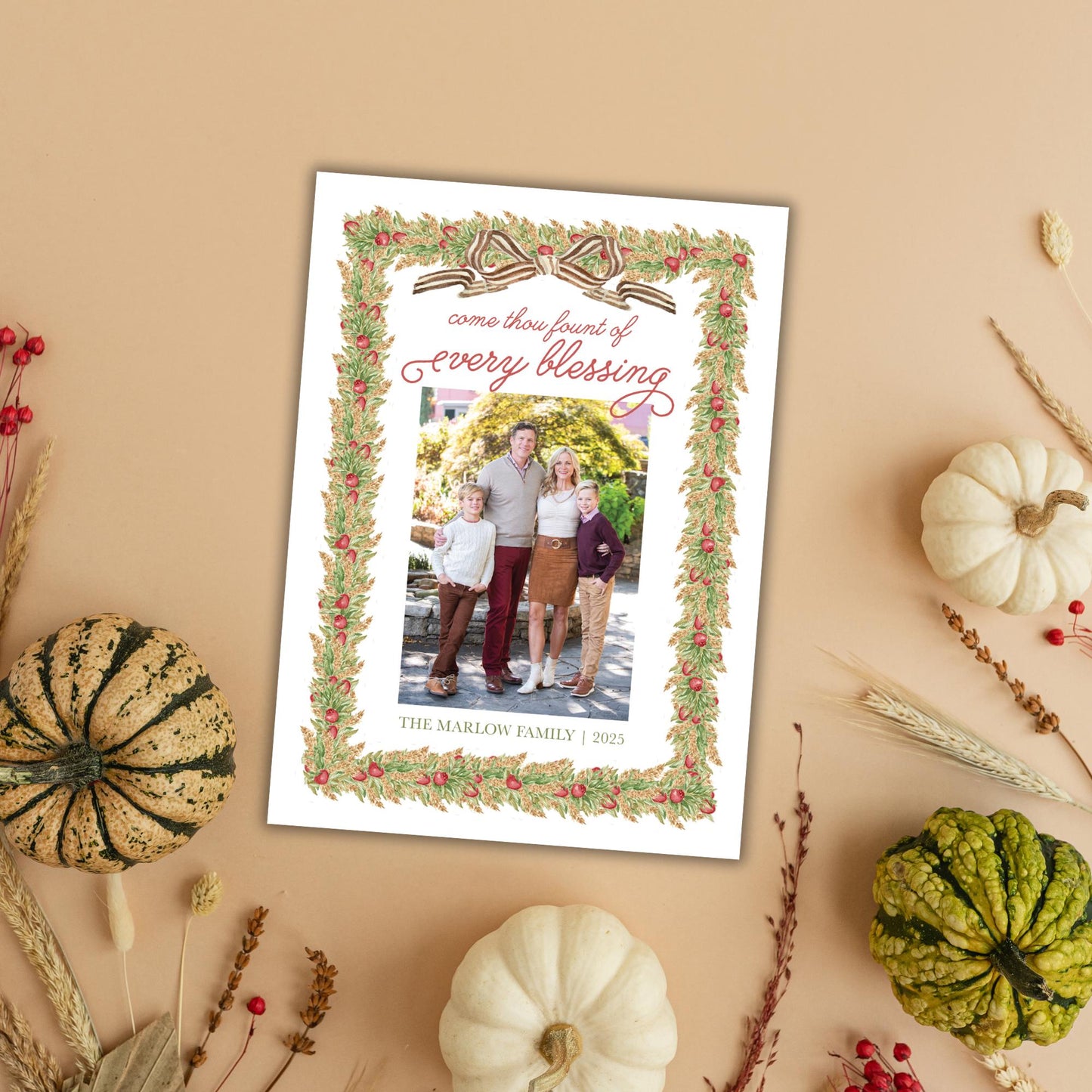 a holiday-themed card with a family photo, surrounded by autumn decorations such as gourds, pumpkins, and dried flowers.