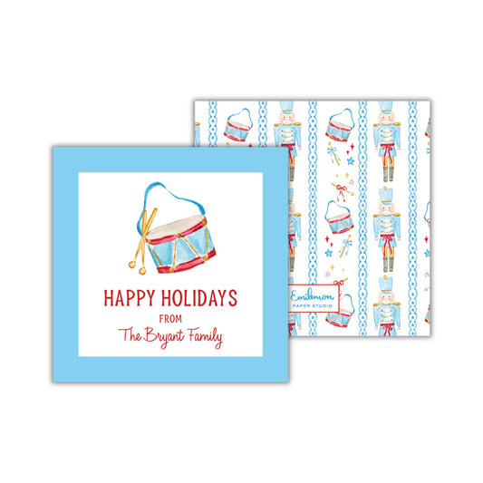 a blue greeting card with a drum and nutcracker motif, along with the text &quot;Happy Holidays from The Bryant Family&quot;.