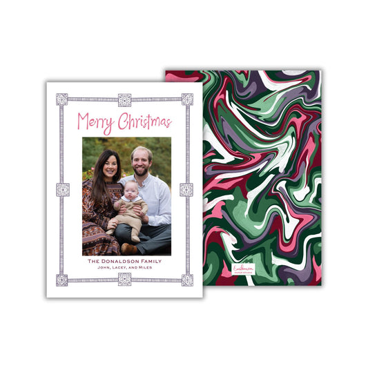 The image is a Christmas card featuring a family portrait of a man, woman, and child. The card has a marbled background and a decorative border.