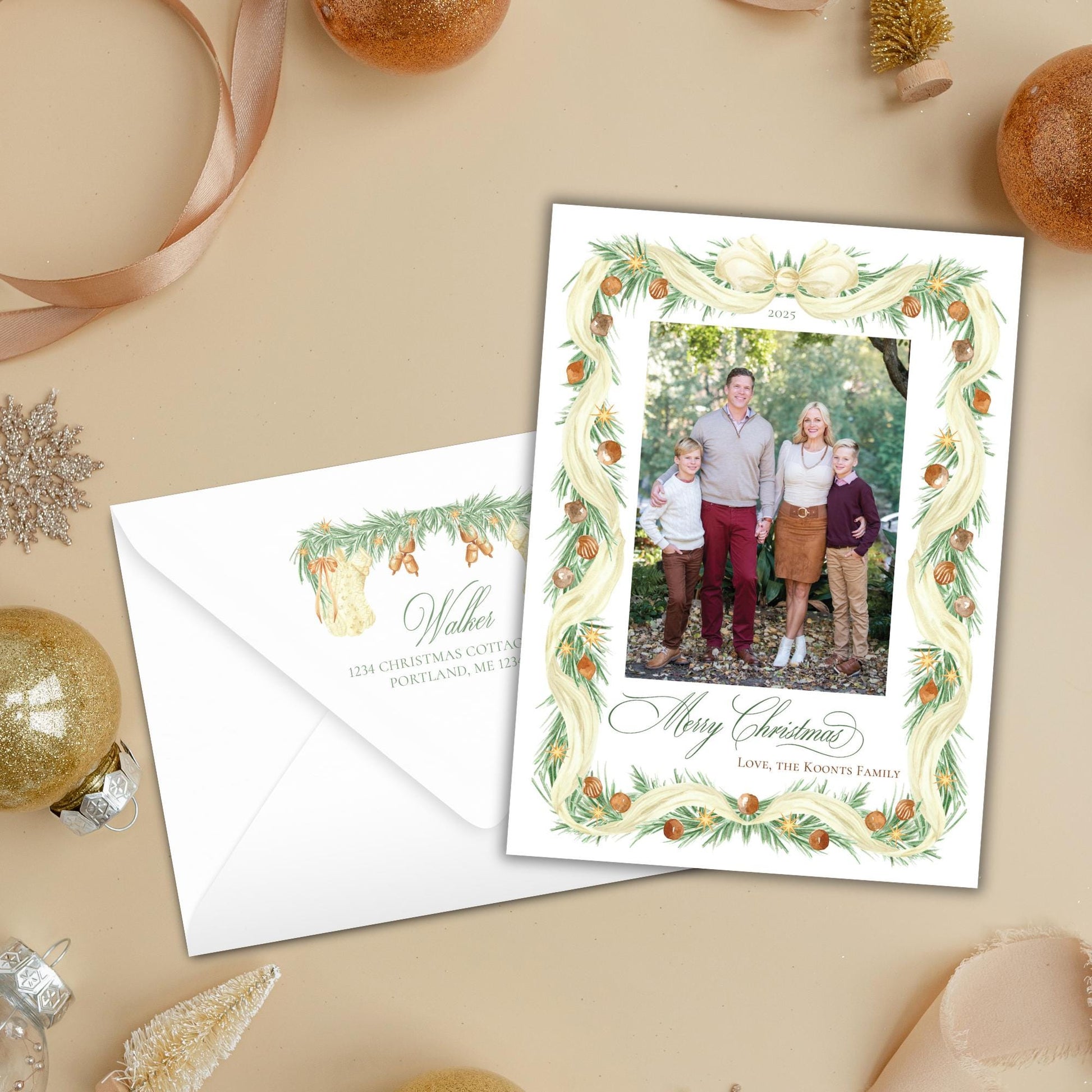 A holiday-themed card with a family photo and a white envelope, surrounded by Christmas ornaments and a ribbon.
