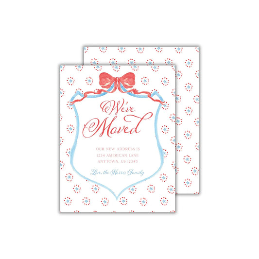 a white card with a red bow on top of it
