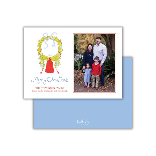 A family portrait of a man, woman, and two children, with a wreath design and the text &quot;Merry Christmas&quot; and &quot;THE STEVENSON FAMILY&quot; printed on the card.