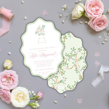 a baby shower invitation with a floral design, surrounded by pink roses and white flowers on a gray background.