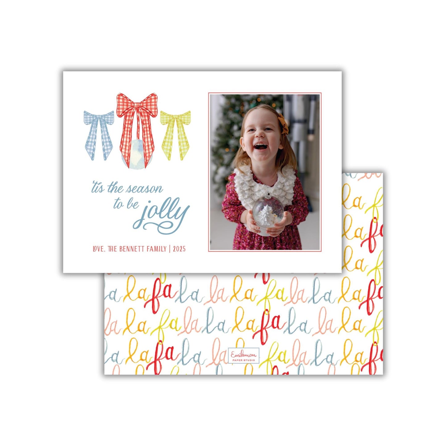 A holiday greeting card featuring a young girl in a red dress holding a snow globe, with a festive background and a repeating pattern of the word &quot;lala&quot; on the card&#39;s background.