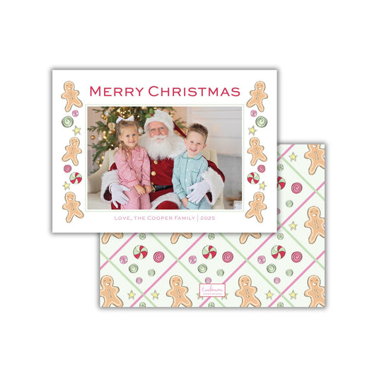 A Christmas card featuring a photo of Santa Claus with two children, surrounded by gingerbread man and candy decorations. The card has a festive design with the text "Merry Christmas" and "Love, the Cooper Family | 2020" printed on it.