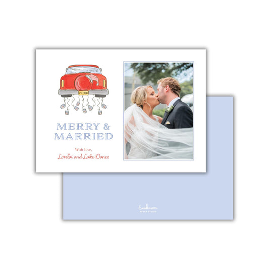 A wedding invitation card with a couple kissing and a red car with a bride and groom on it.